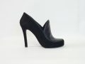 ljutikova-black-suede-pumps-back.jpg ALT: Black suede designer pump by LJUTIKOVA showing the slender stiletto heel from behind.
